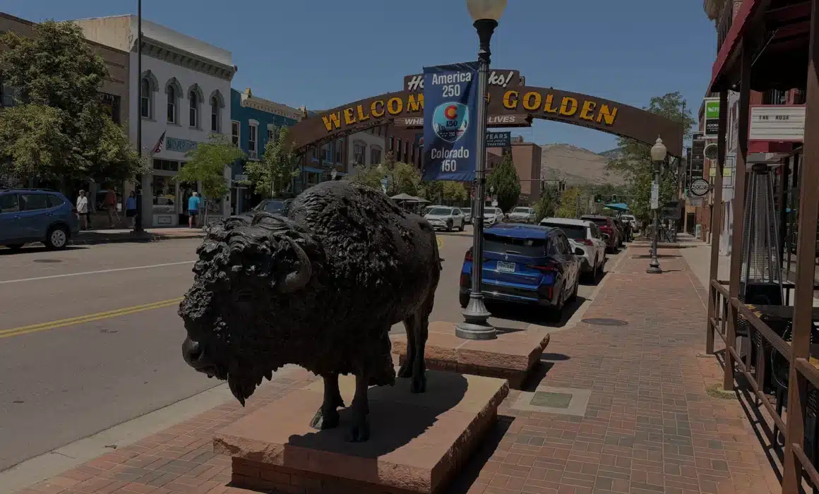 Historic downtown Golden, Colorado at golden hour beneath the Welcome to Golden arch
